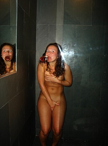 A nude bitch with her pussy hanging out is getting fucked up on some cheap ass wine while looking at herself in the mirror.