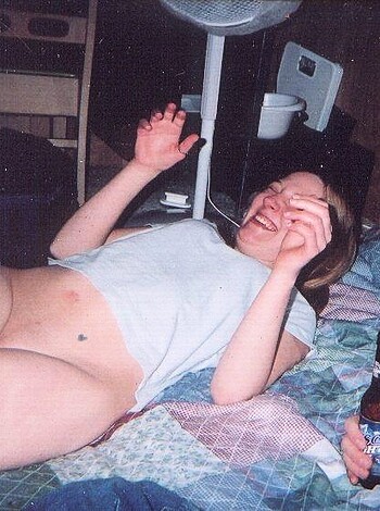 """
A naked dude with a beer sitting on a bed talking to his hot chick. They look like they're having some quality time together, not giving a fuck about anything else.
"""