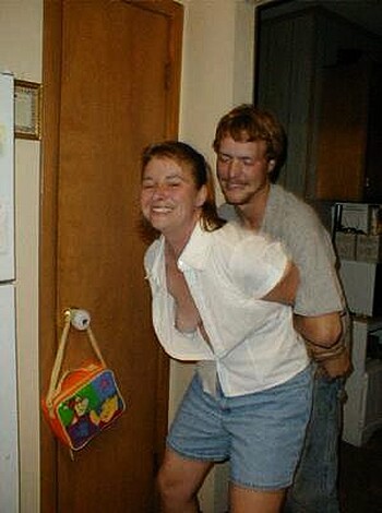 A woman is groping a guy's ass in this image.
