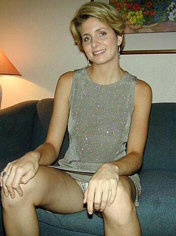 This picture is of a bitch in a glittery fucking dress sitting her fat ass down on some tacky-ass furniture, probably at some trashy motel or something.