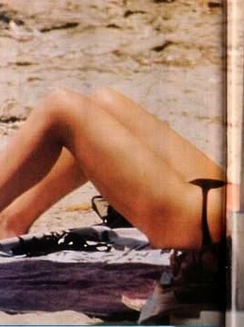 Bikini-less babe lying down on sandy shore with tits and pussy bare for all to see, fucking hot!