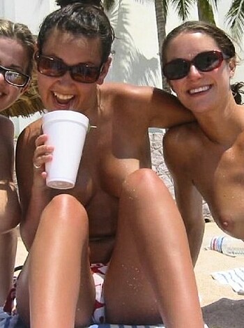 Nudist girls take a drink at the beach  - Photo 46