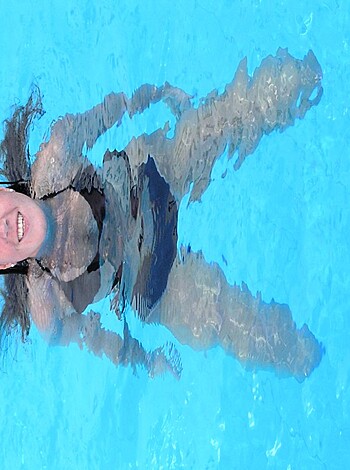"Chick in bikini chillin' by the pool."