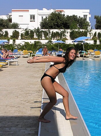 Vulgar description: "Dude, check out this hot babe with the tight ass and big tits, in a skimpy black two-piece by the pool."