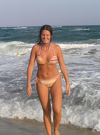 """
Look at this fucking chick strutting her ass on the sandy shore in some skimpy bikini shit, dude. Fucking hot!
"""