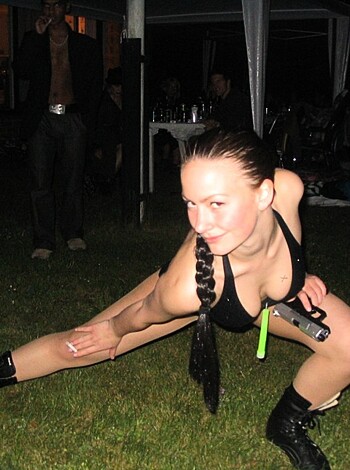 A chick is taking a shitty on her knees.