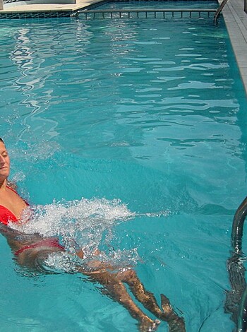 Vulgarity warning: This image is of a fat fucker in a tiny, red speedo, splashing around in the pool like a drowning whale.
