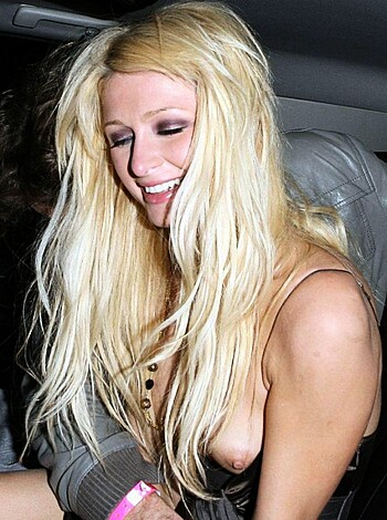 Blonde bimbo boobs boasting her bra in a hot sedan, with her tits touching her chin and her tongue sticking out of her mouth while she flashes her pearly whites.