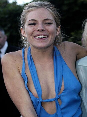 "Busty blonde babe in sexy blue tee."