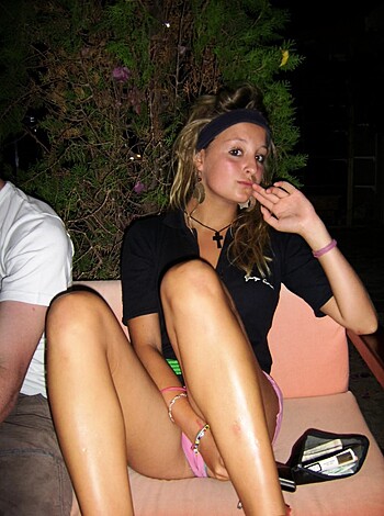 "Check out this fuckin' picture of some chick with a black t-shirt, sittin' all crossed-legged on a couch, chewin' on her goddamn finger while lookin' at shit in her hand."