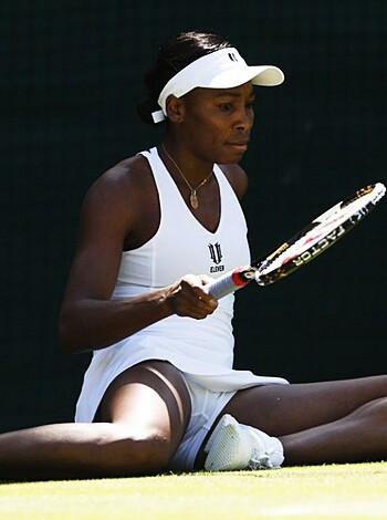 A fucking hot babe with a massive rack is showing off her sweet tits and ass as she holds up her tennis racket, all while wearing some tight white shorts that barely cover her luscious pussy.