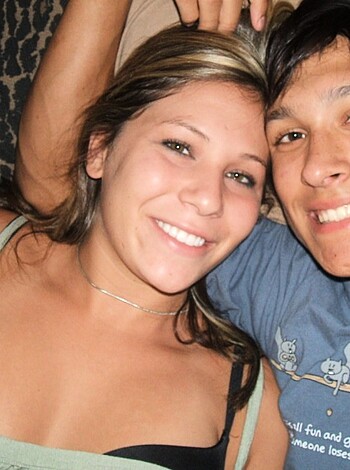 A fucking couple is cuddling in their goddamn bed, with the bitch's boobs sticking out and the guy wearing a dumbass t-shirt.