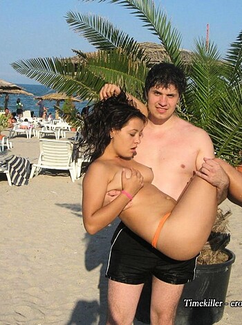 Bitch is fucking some dude with his ass up against the shore while they stand on the sand.