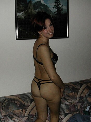 """
The bitch is in lacy black panties, giving you a glimpse of her ass cheeks and tits.
""" 
OR 
"""
A skanky slut with a perfect booty wears black lingerie, flashing her boobs and crack.
"""