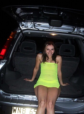 Here's a naked chick in the trunk of a car, and she looks like she's having a good time with her legs spread open wide.