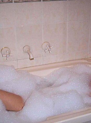 Vulgar description:
Here's a hot chick washing her dirty ass in some sudsy water while clad in a flimsy two-piece swimsuit that barely covers her tits and pussy.