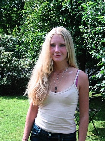 A busty cunt is flashing her tits in this pic.