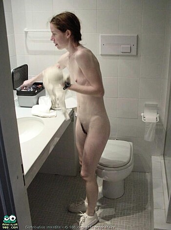 Here's a vulgar description of the image: A fat, hairy broad with tits like watermelons scrubbing her shithole toilet in her ass-ugly socks while flashing her crack like a fuckin' whore.