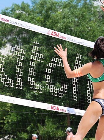 A hot-ass chick in a skimpy bikini is slamming the shit out of a volleyball, launching it high above her head and smacking it with authority towards some fucking dudes on the other side of the net.
