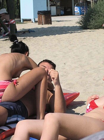 """
Hairy beached blonde in red string thong, showing off her juicy ass and tits.
"""