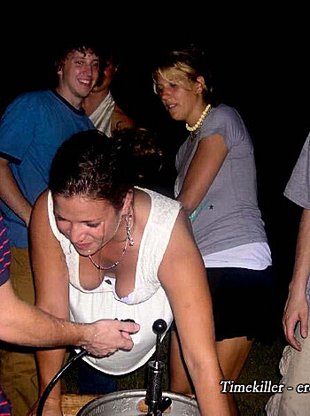 Here's a description of a woman in a white dress, sitting on a guy's lap with her ass up in the air and her tits hanging out like she doesn't give a fuck.