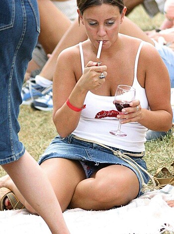 Breasts bouncing with each step, tight ass cheeks popping out, thighs spread wide, as she walks on the greenery, sips from a wine glass while inhaling smoke from her Marlboro Red.