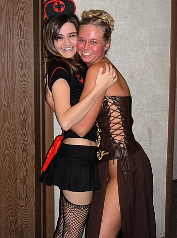 Vulgar description of image: "Check out these hot babes, one's dressed like a fuckin' sexy nurse while the other looks like some kinda princess shit; they're taking a pic together and it's pretty fucking obvious why."