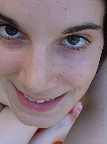 """
Close-up view of a chick’s face and titties.
"""