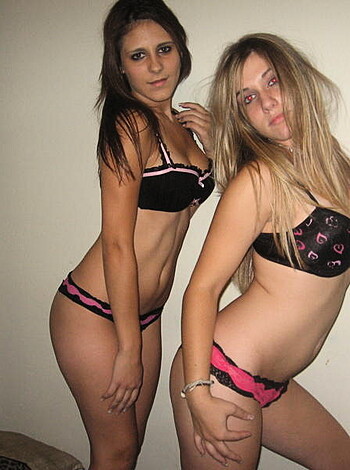 "Here's some hot teenage titty action - two busty babes in their underwear, fucking around on a bed."