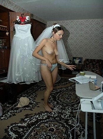Vulgar description of image: "Fuckin' bitch standin' naked in a room with a fuckin' weddin' dress, feelin' up her tits while lookin' at some stupid-ass veil."