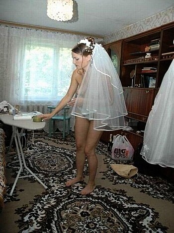 """
A bitch in her wedding dress getting irons with her tits out.
"""