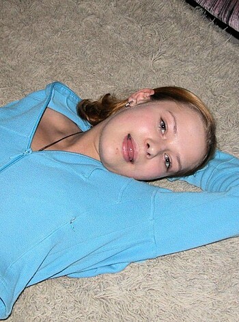 Here's the description: "A naked babe is lying on her back on the floor, smirking while holding her hand on her ass."