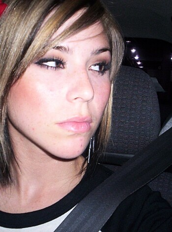 Here's a shot of some chick in a f*ckin' car, starin' right at the goddamn camera like she owns the place.