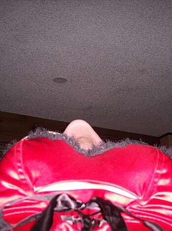 Here's a fucking bitch, dressed in red latex, showin off her bare ass for the camera to see.