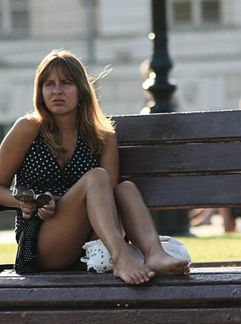 Here's a description of a barefoot bitch sittin' on a bench with her fat ass cheeks hangin' out.