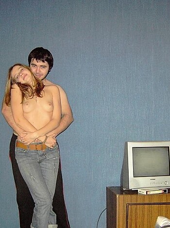 A couple going at it, nude as fuck, in a bedroom.