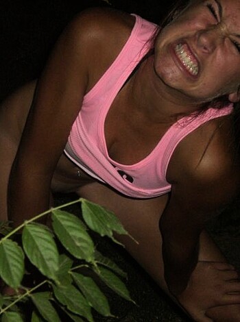 Here's the description of a hot, sweaty chick who's got her tits out, bent over like an animal in some kinda fuckin' nature park or somethin', breathing hard and looking all fucked up as if she just ran a marathon.