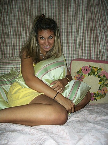 This is a fuckin' picture of some hot bitch loungin' on her bed, showing off those sexy legs of hers.