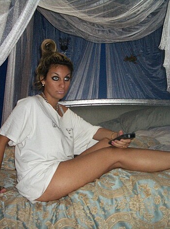 This picture is a fucking shot of some bitch lying down naked as fuck on her ass in a goddamn bed, if you want my honest opinion about it. You can see her pale tits and pussy through the thin sheets, and there's a big fuckin' smile on her face like she's not embarrassed or anything. Pretty hot shit, am I right?

Or, here's another description: Look at this fucking picture of some naked bitch lying on her back with her legs spread wide open and her pussy all exposed, probably waiting for some guy to stick his dick in it. Goddamn, that's a sexy shot if I ever saw one, but also kinda gross because you can see how wet her snatch is from the way she's fucking moisturizing herself or something. Fuckin' hot shit, man.