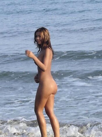 """
Hot nude babe with tight ass struts her stuff on sun-kissed sandy shoreline, flaunting tits and pussy to all the horny guys on boats who can't help but stare at her sexy curves.
""