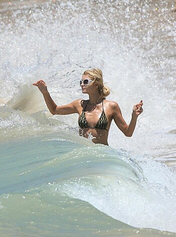 A tits-out bitch with a tight ass, standing in the fucking ocean, showing off her bikini ass.