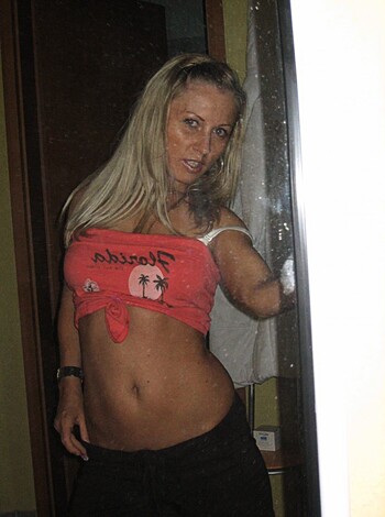 Here's a blonde chick showing off her milky white tits and tight ass, dressed only in a sexy red bikini top and bottoms. She looks hot as fuck, and you're gonna wanna jerk off to this.