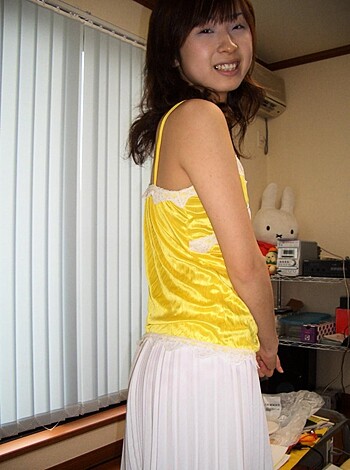 A bimbo in a daisy dukes and croptop shirt is posing for the camera.