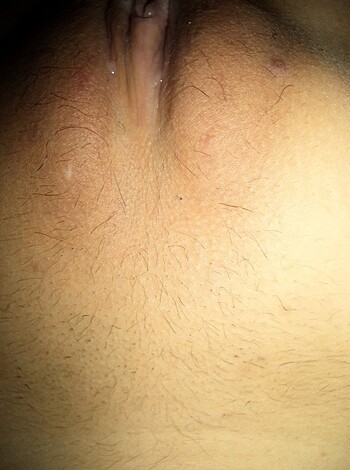 "Close-up of a hairy, dick-sporting dude with his asshole hanging out for all to see."