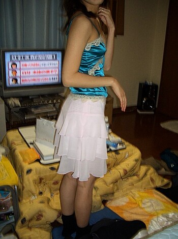 Here's a vulgar description of a woman wearing a tight blue dress fucking her way through a living room.