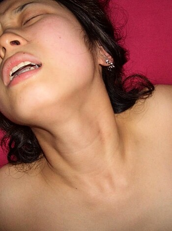 A fuckin' nude broad lies on a bed with her pussy and tits all exposed, ready to get boned by some dude.