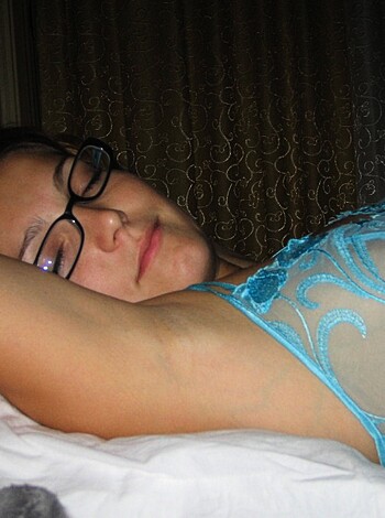 "Here's a picture of a hot bitch with thick glasses and a mild smile lying flat on her back like some pornstar, probably getting off while her man fucks her doggy-style."