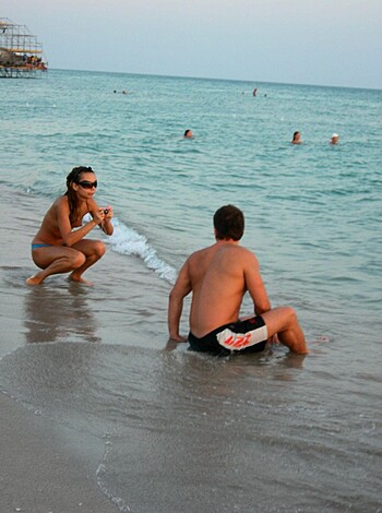 Vulgar description: "Fat fuckin' couple suckin' dick on the sandy shore."