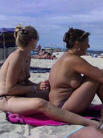 "Yo, check out these two tits-out chicks basking in the sand."