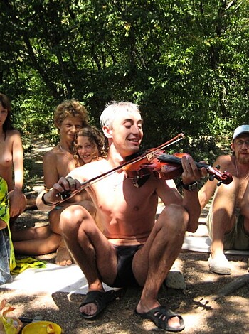 Fucking hell, there's a fuckton of naked assholes chillin' out in the goddamn woods while some dickhead plays his fuckin' violin without a fuckin' shirt on.